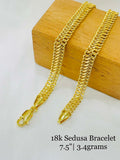 Gold bracelet on a wooden box with text indicating '18k Sedusa Bracelet' and dimensions.