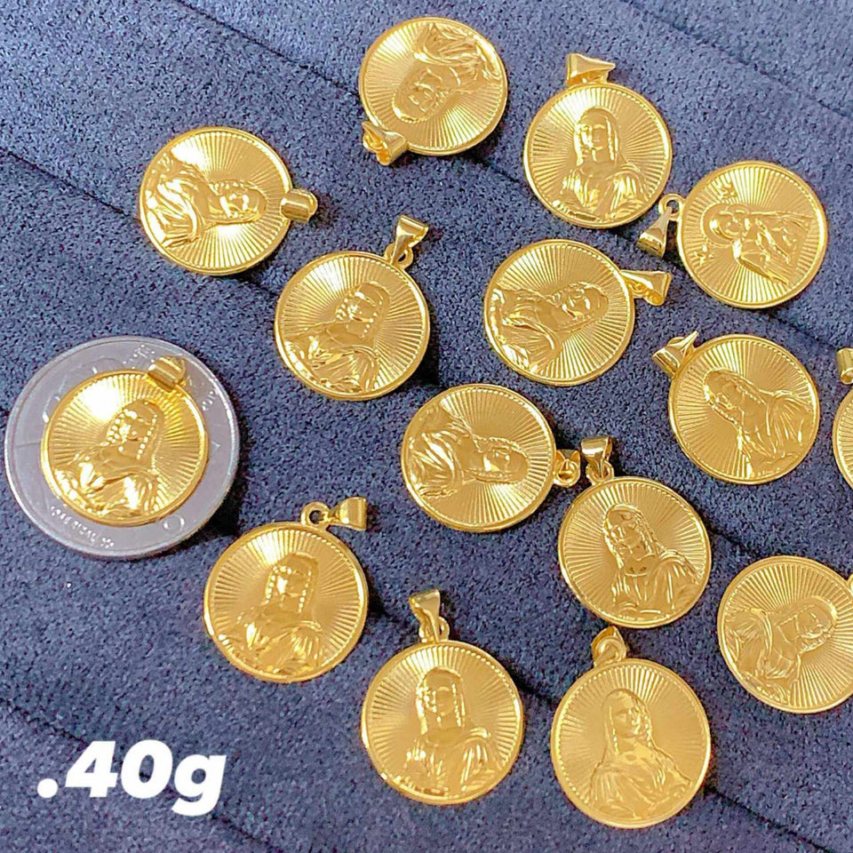 Gold coins and a silver coin on a blue fabric background