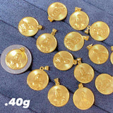 Gold coins and a silver coin on a blue fabric background